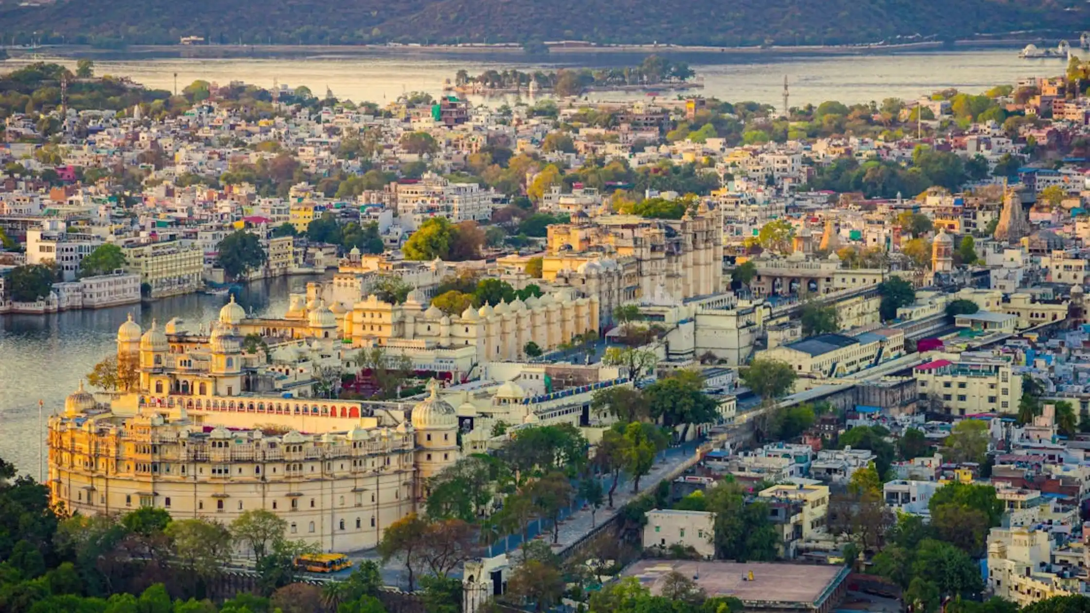 A panoramic view of Udaipur, India, showcasing its stunning lakes, palaces, and vibrant architecture under a clear sky