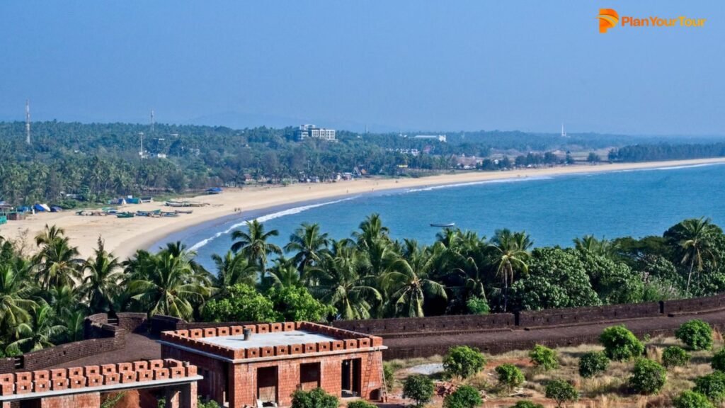 a beach with palm trees and buildings
 : Bekal Fort , Kerala