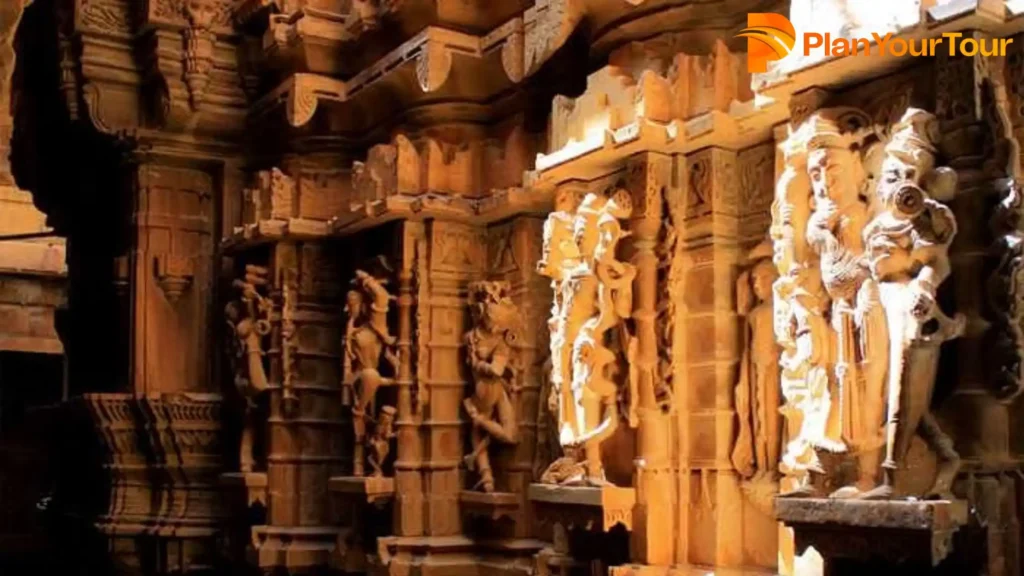 Interior view of a Chandraprabhu Temple, Jaisalmer  featuring intricately carved statues adorning the walls and pillars, showcasing exquisite craftsmanship