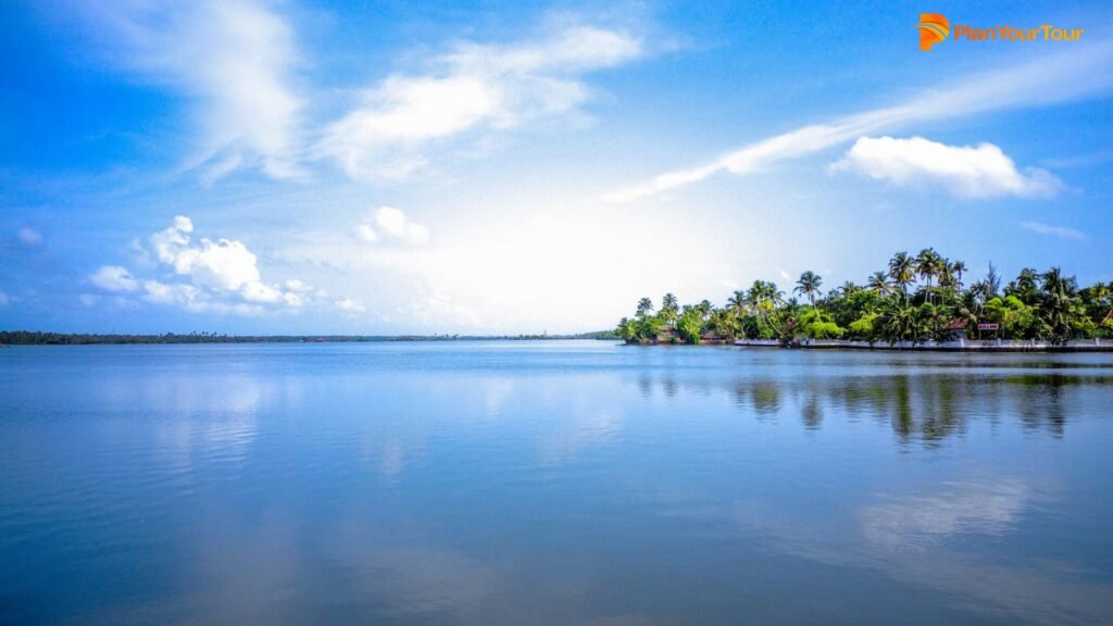 a body of water with trees and a blue sky : Kochi, Kerala
