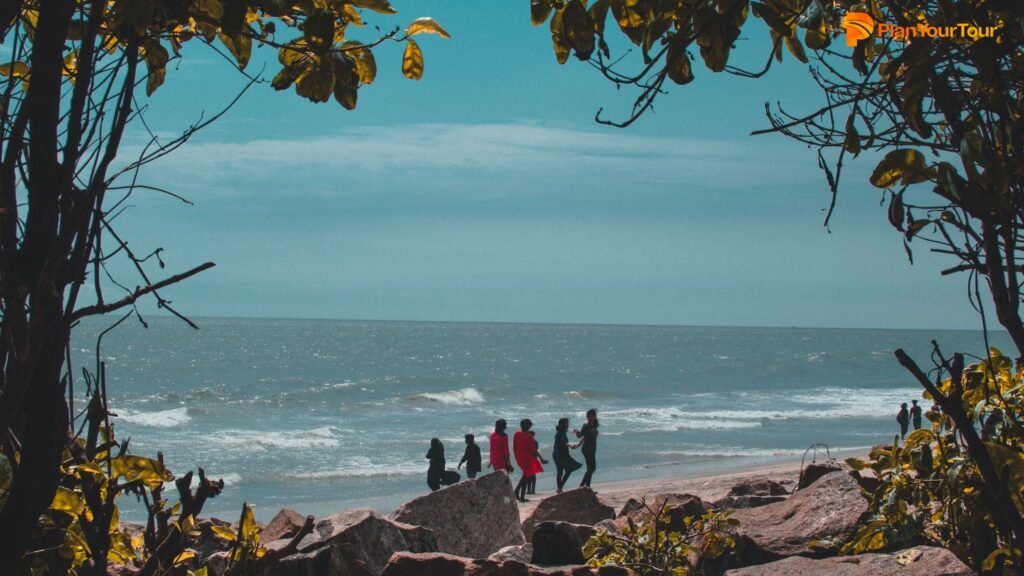 a group of people walking on a beach
: Kozhikode Beach , Kerala