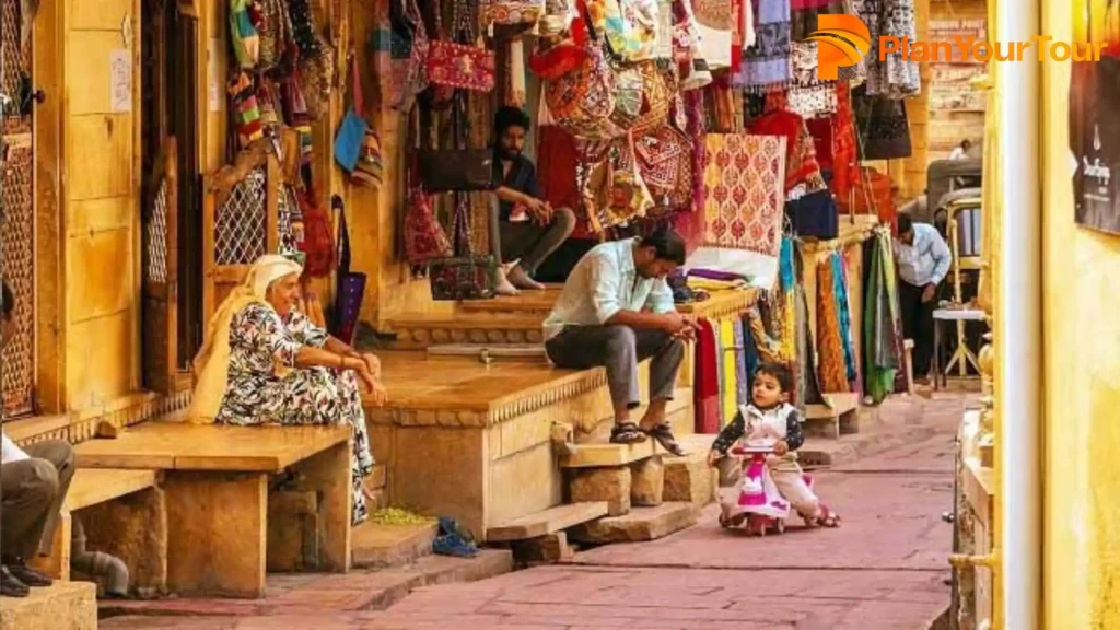 A narrow alleyway with people who buy and sell handcraft items in the Sadar bazar, Jaisalmer 