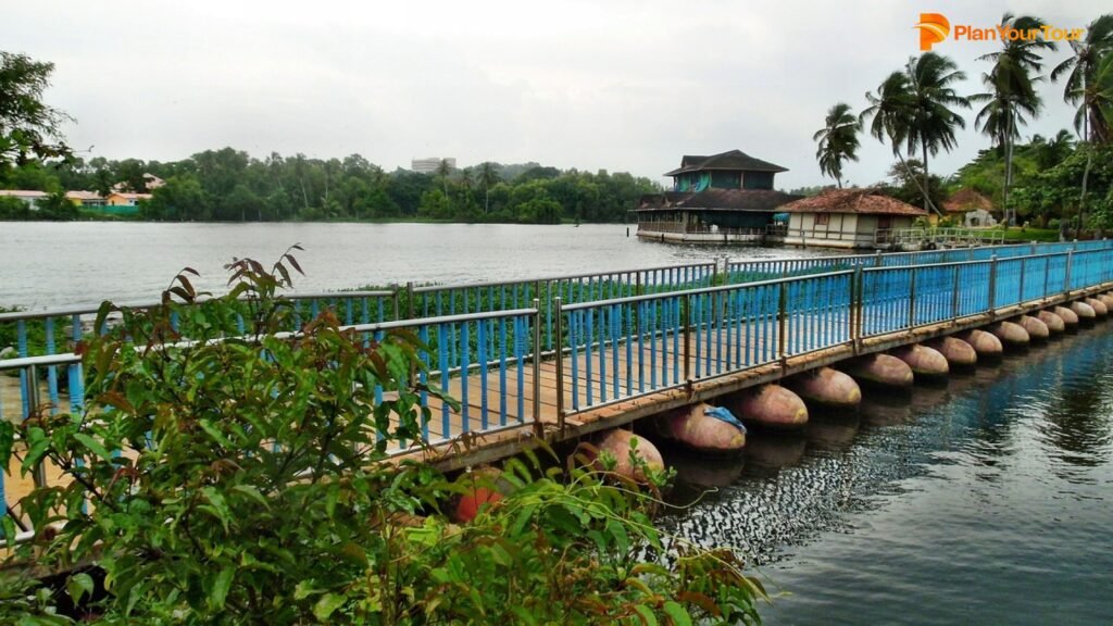 a bridge over water with a house on the side : Trivandrum , Kerala
