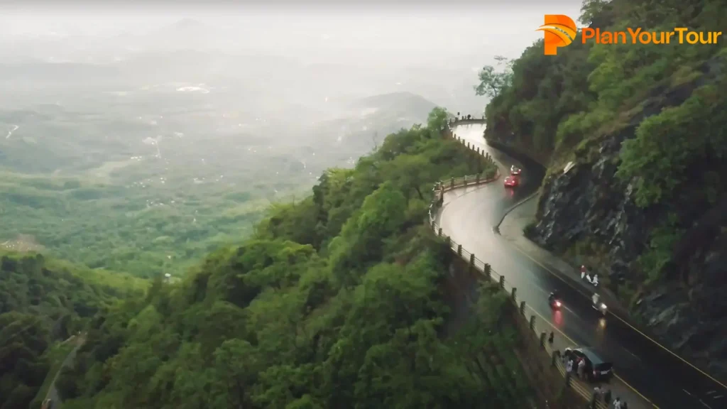 picturesque view of lush green hills under a bright sky around the Lakkidi View Point