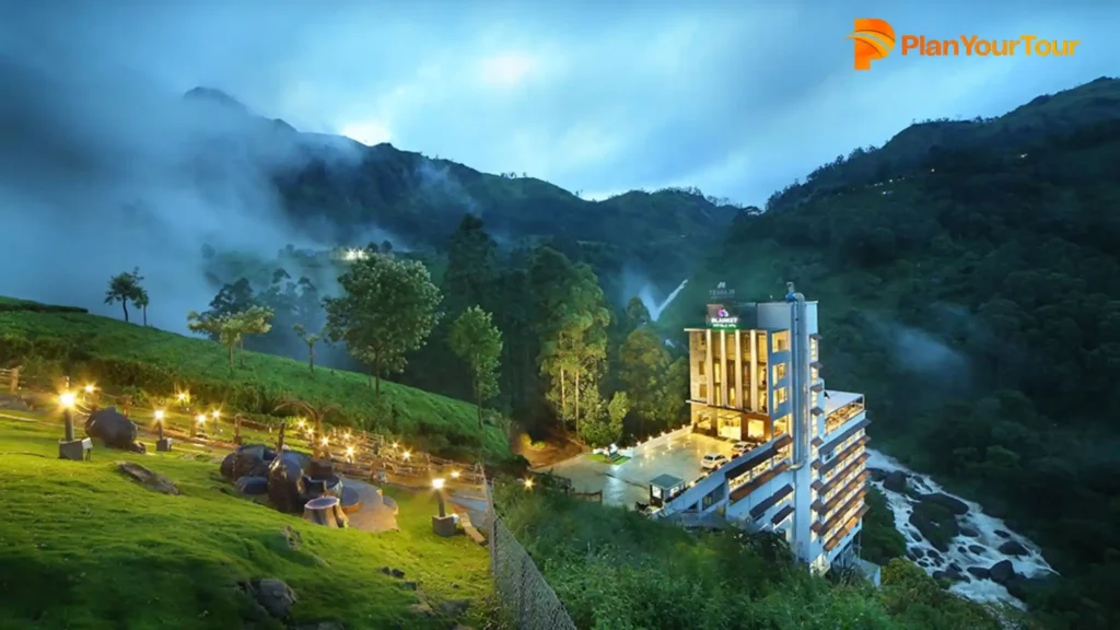 a building with lights on top of a hill of 
Blanket Resort & Spa which is 5-star resort in Munnar