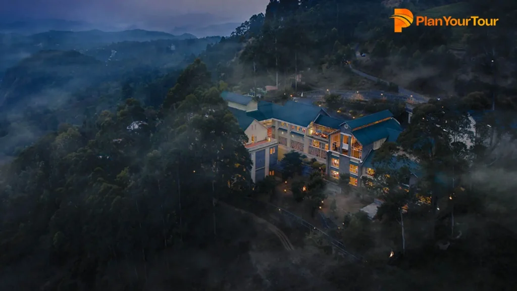 a building with lights on it around hills of Devonshire Greens, 4-star Resort in Munnar
