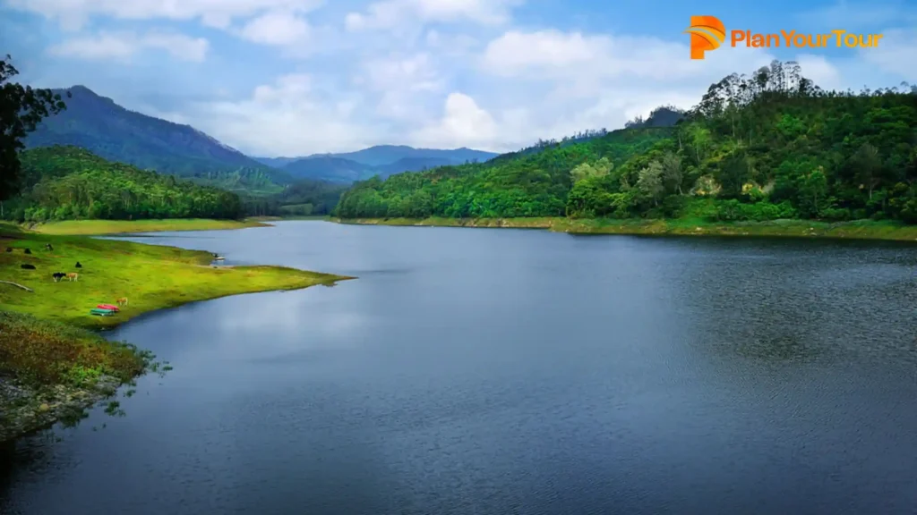 a Kundala lake surrounded by trees and mountains
