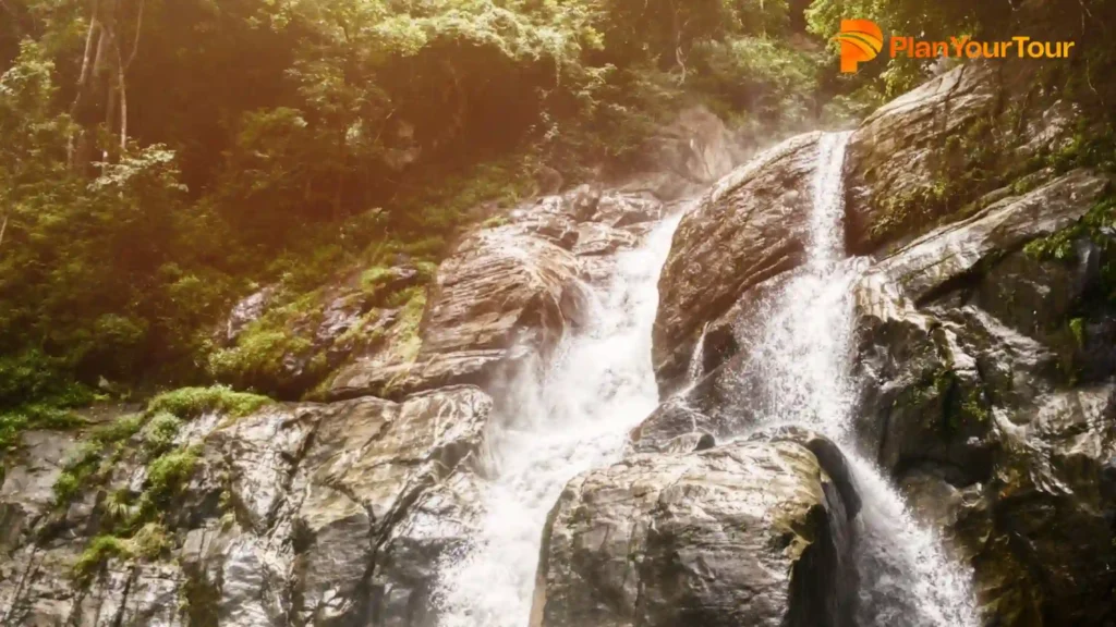 a Meenmutty  waterfall on a rocky cliff , most beautiful places in Wayanad
