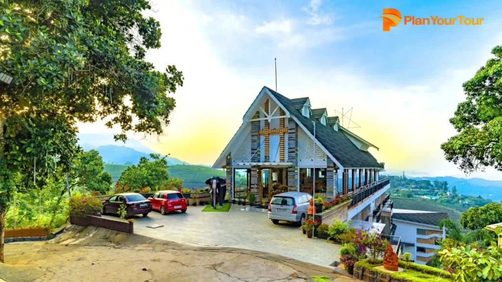 a building with cars parked on the side of it at Parakkat Nature Resort, budget-friendly Resort in Munnar
