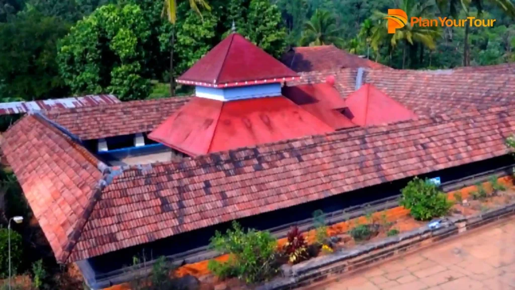 a building with a red roof of Thirunelli Temple, must see places in Wayanad
