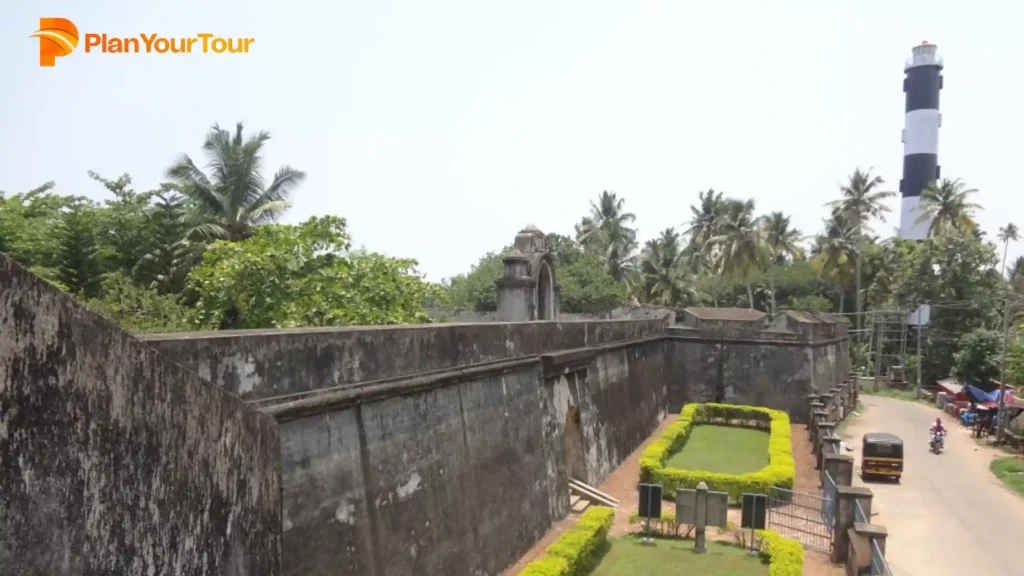 a stone wall with a garden and trees near Varkala Lighthouse which must-see place to visit in Varkala