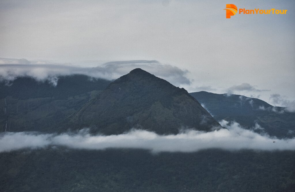 Anamudi View from Rajamala surrounded by misty mountains in Munnar