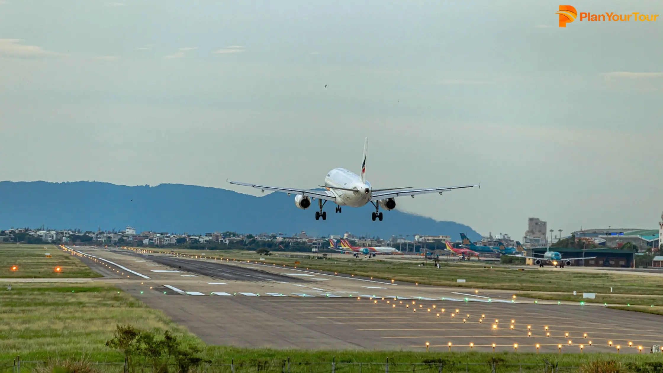 A commercial jetliner takes off from an airport runway, showcasing its powerful engines and upward trajectory.